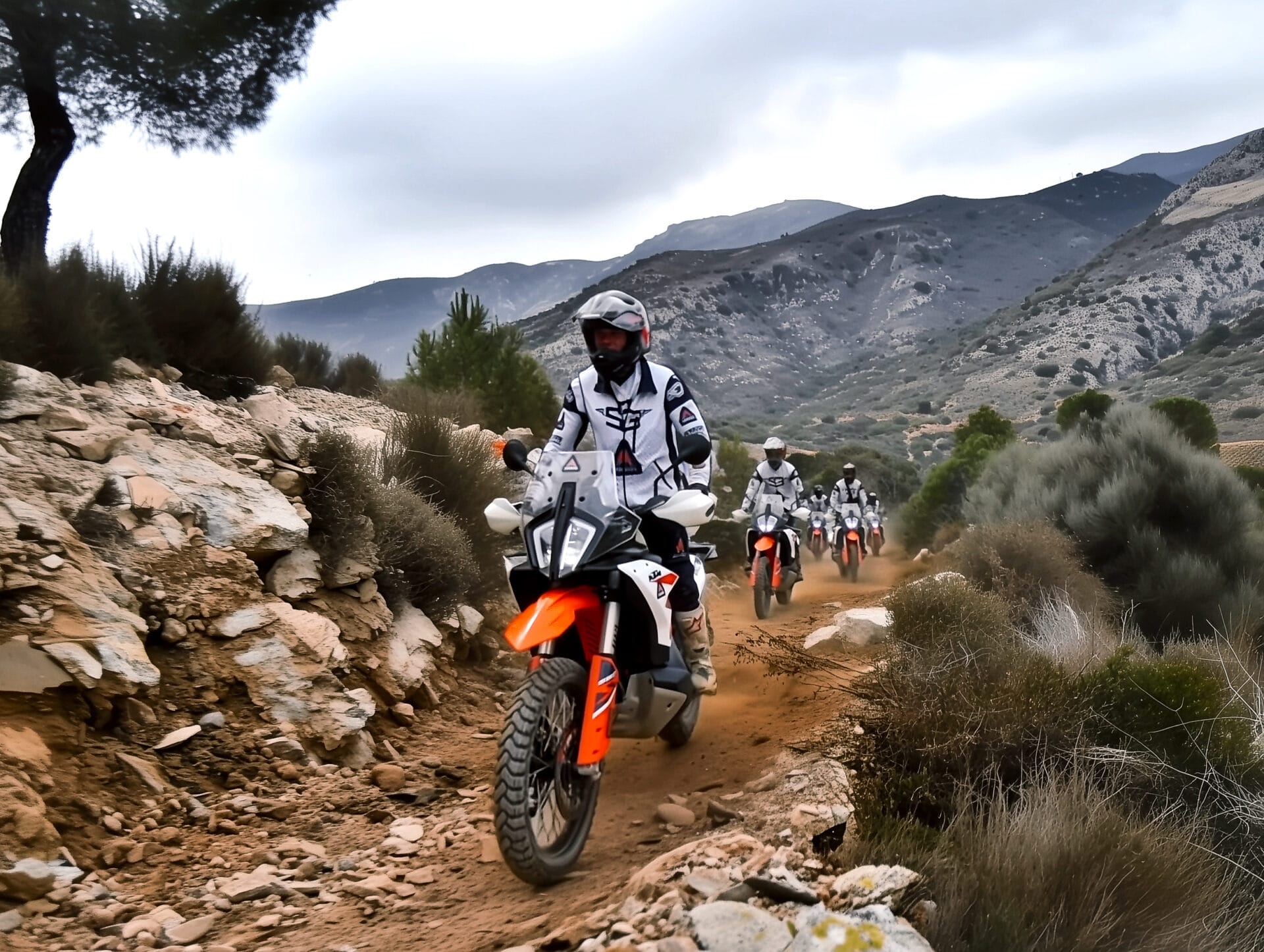 Group of riders on KTM adventure bikes on a rocky mountain trail in southern Spain