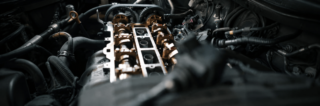 Close-up of an exposed car engine with camshafts and valves