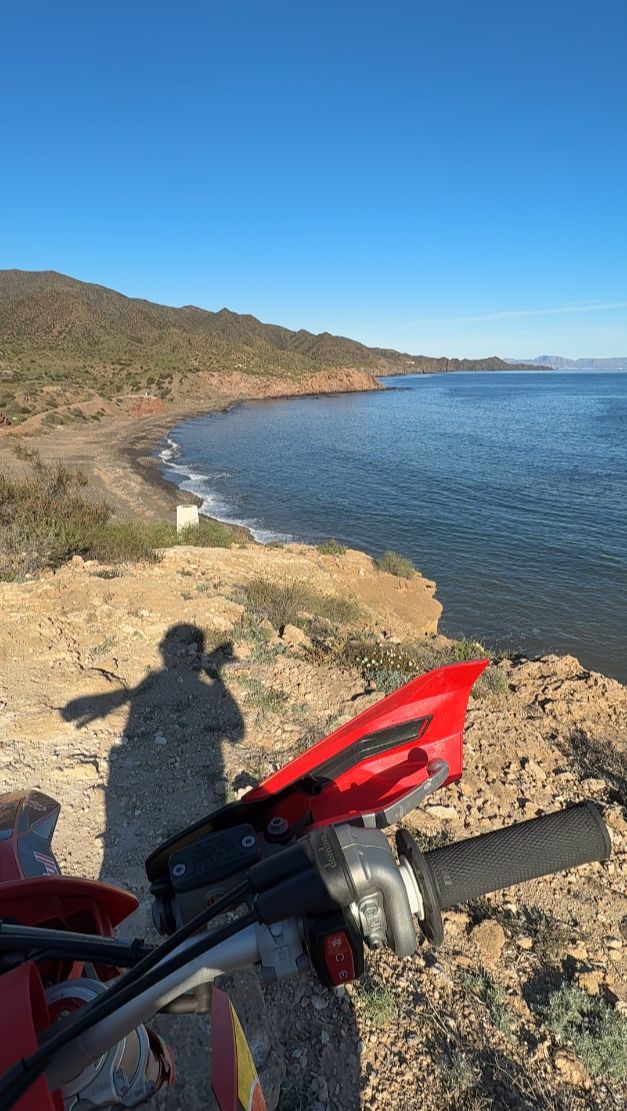 Enduro bike at a clifftop viewpoint over the Mediterranean coast of Murcia