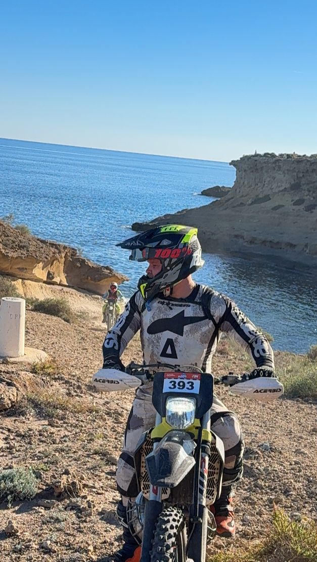Enduro rider on a rocky coastal trail on the Murcia coast