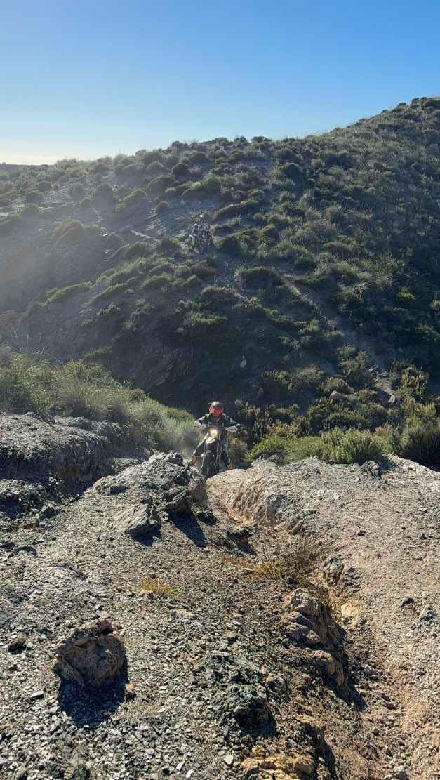 Enduro rider climbing a steep rocky ridge in the Murcia hills