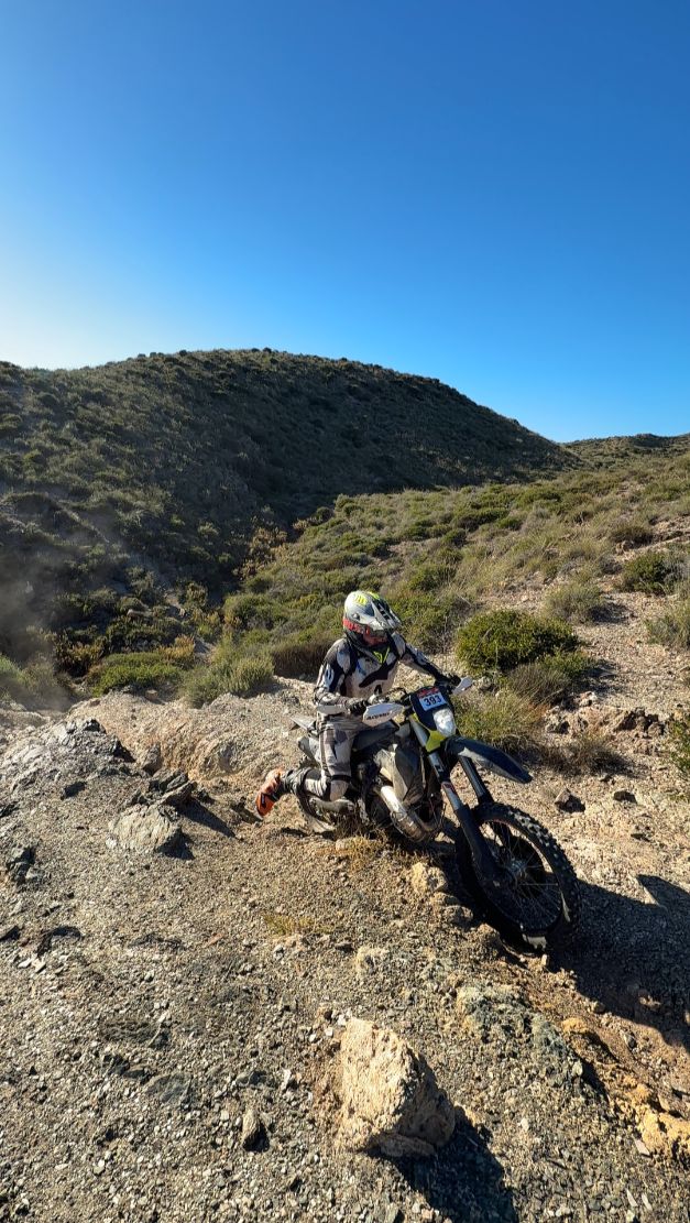 Enduro rider riding down a rocky hillside track near Lorca