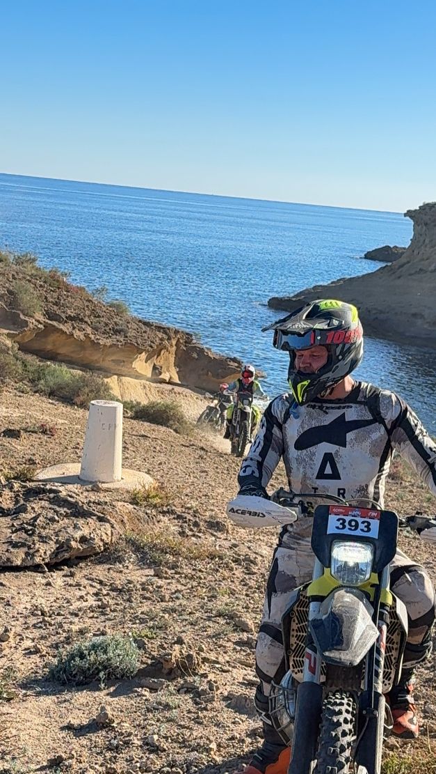 Enduro rider next to the sandstone cliffs of the Murcia coast