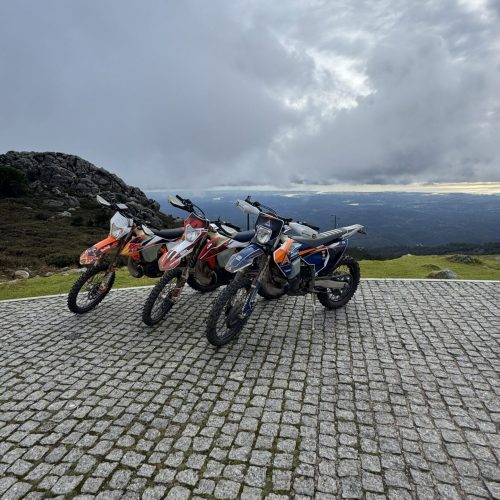 Three enduro motorcycles parked at a mountain viewpoint on the 500 km Enduro Tour in Spain
