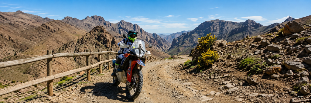 Adventure rider on a gravel mountain track in rugged rocky mountains